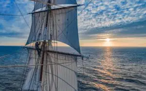 View from Morgenster’s bowsprit as she sails toward the horizon at sunset near Brittany
