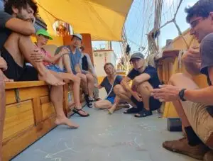 Crew guiding guests through sailing instruments on the Morgenster