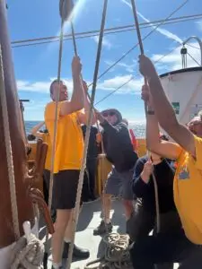 Guests helping with the ropes during a Tall Ship Morgenster day trip on the UK south coast.